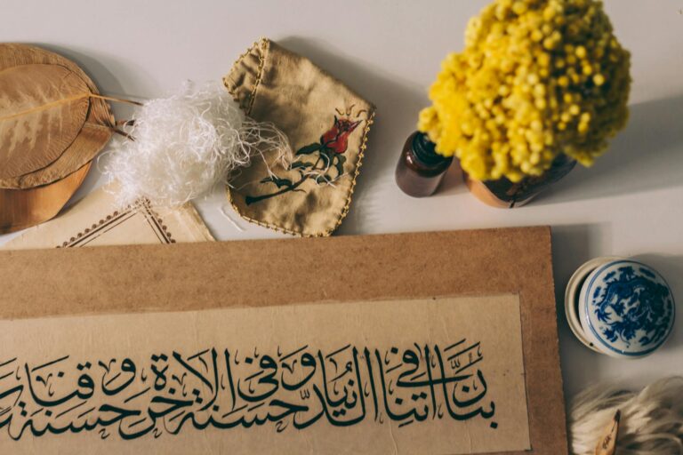 Artistic display of Arabic calligraphy paired with natural elements and floral accents.